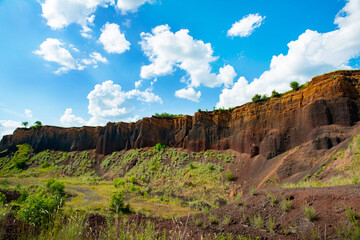 limestone cliffs from the old volcano and green vegetation in the middle of the plain - 434335347