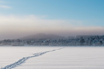 Path formed in the snow on the frozen lake Storsjön in Östersund - 434335775