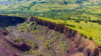 limestone cliffs from the old volcano and green vegetation in the middle of the plain - 434335923