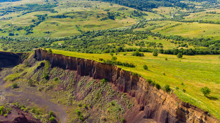 limestone cliffs from the old volcano and green vegetation in the middle of the plain - 434336140