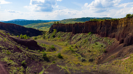 limestone cliffs from the old volcano and green vegetation in the middle of the plain - 434336393