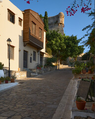 A historic alley leads upward to the historic castle Rethimno Crete Greece. The lane is seamed with greenery