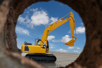 Excavator are digging the soil in the tunnel construction site on the blue sky background