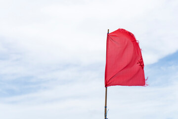 Red flag warning flags danger wind blue sky background