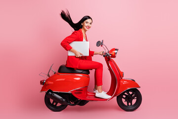 Fototapeta na wymiar Full length profile side photo of young girl happy smile hold laptop ride bike meeting isolated over pink color background