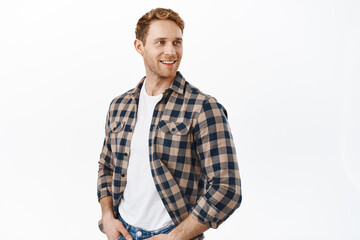 Attractive caucasian man with strong masculine body and red hair, looking over his shoulder at promotional banner, turn head right at copyspace logo, standing over white background
