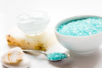Home cosmetic with cream and blue sea salt on white background