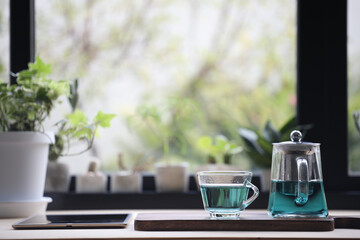 Butterfly pea tea juice and tablet on wooden table