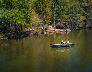 Fototapeta na wymiar boats on the river people summer tree vacation canoe reflection water usa New York 