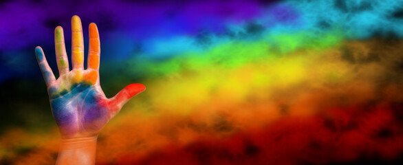 Gay pride concept. The hand is painted with a rainbow. Gay pride lgbt b rainbow flag - obrazy, fototapety, plakaty