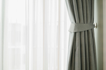 Glass window with white translucent curtain.Close up sheer curtain with beautiful sunlight in the morning