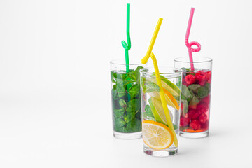 Cocktails isolated on white background. Lemon and lime, mint and raspberries cocktails.