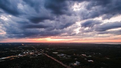 Obraz premium Sunset and clouds over town.