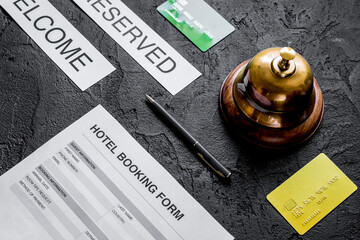 booking form for hotel room reservation, pen and ring dark background