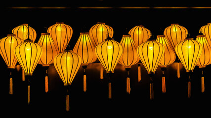 Festive paper lanterns on dark background, Chinese New Year celebration concept. Glowing, illumination, holiday symbol