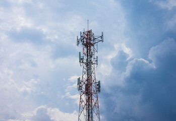 Telecommunication tower on blue sky background with clouds.  