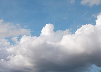 white cirrus, feathery clouds against spring bright blue cloudy sky on sunny day in England