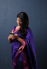 Advertisement concept - Pretty Indian young woman showing smartphone or mobile blank screen 