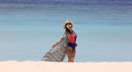 beautiful girl in bikini on the seashore of a tropical resort
