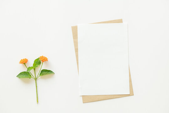 Mockup With Flowers. Blank Space For Text. Empty Paper Sheet On Rustic Table Shot From Above. Top View, Flat Lay, Copy Space.