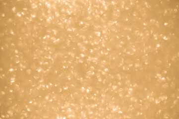Gold glitters background. shimmering blur spot lights Bokeh Shiny gold light background.