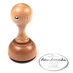 wooden rubber stamp and HANDMADE WITH LOVE imprint on white background