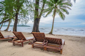 Wooden chair beside the beach with beautiful idyllic seascape view on kohkood island.Koh Kood, also known as Ko Kut, is an island in the Gulf of Thailand