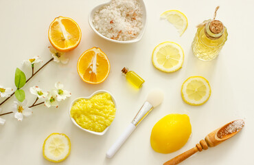 Natural cosmetic products for the body with vitamin C, top view, flat lay. Citrus fruits, bottles with cosmetics, sea salt, scrab, plastics of lemons, oranges, limes, spices, herbs, oils