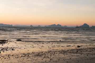 Nature background of seashore beach wave coastline, at dawn or sun set on water surface for holiday relaxation lifestyle landscape concept