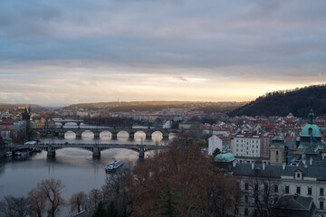 View of the bridge at sunset in Prague from the park