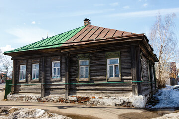 Old wooden house with two-color roof in the street of Nerehta. Traditional Russian rural style. Beautiful city in Kostroma region and applicant for participation in Golden Ring of Russia  