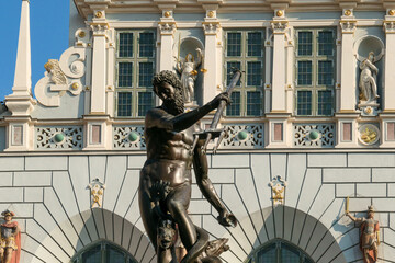The Neptune's Fountain in Old Town of Gdansk, Poland. The fountain is located in the central point. Town Hall building in the back. City tour. Clear and bright day. © Chris