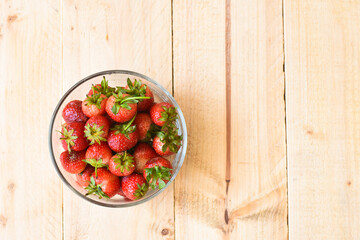 Strawberry in glass bowl on wooden background
- 434369300