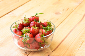 Strawberry in glass bowl on wooden background
- 434369369