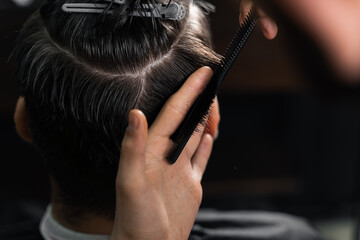 Naklejka premium Barber making hairstyle for confident bearded hipster. Advertising for barbershop and men's beauty salon.