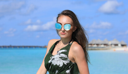 beautiful girl in dress on a tropical sea resort