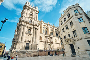 The Cathedral of Malaga, Spain, was completed in 1782. It is one of the largest cathedrals in the country and is located in the center of the city. Side view with lovely blue sky with clouds