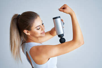 Woman getting anti-cellulite and anti-fat therapy over light background