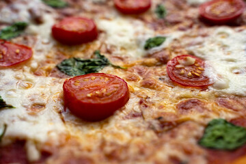 Close-up of pizza margherita with tomatoes, basil and cheese