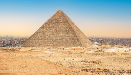 Fototapeta na wymiar Ancient Pyramid Against blue Sky. Pyramid Chufu Cheops - known as the Great Pyramid. Cheops pyramid in Giza
