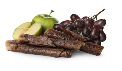 Delicious fruit leather rolls, apples and grapes on white background