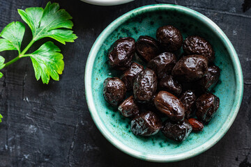 dried olives sun-dried aromatic dry fruit appetizer or salad addition on the table healthy food meal snack copy space food background rustic. top view