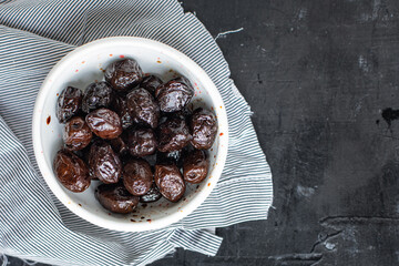 dried olives sun-dried aromatic dry fruit appetizer or salad addition on the table healthy food meal snack copy space food background rustic. top view
