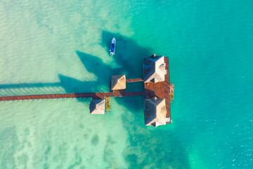 Aerial top down view from drone of a luxurious tropical island paradise resort in Maldives with...