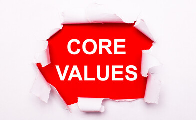Torn white paper lies on a red background. On red, the text is white CORE VALUES