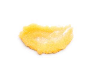 Smear of orange body scrub isolated on white, top view