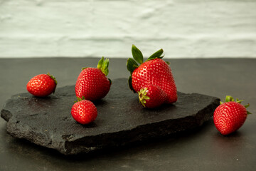 Ripe juicy red beautiful strawberry close-up is an appetizing fresh snack