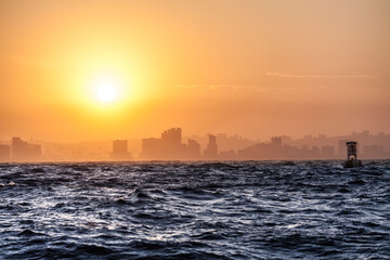 Approaching Durban from sea at sunset with big waves on the Indian Ocean, South Africa