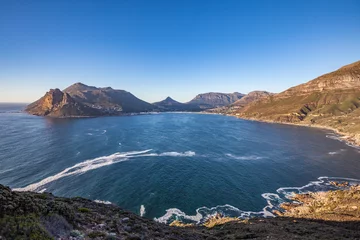 Foto auf Leinwand panaramic view on Hout Bay, the southern Harbor of Cape Town, with characteristic table cloth clouds rolling over the mountains,South Africa, landscape  © Uwe