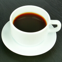 White cup of coffee on a black .